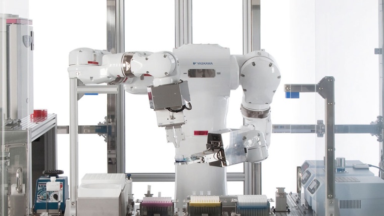 The MOTOMAN dual arm robot in a biomedical cell where it performs all the...